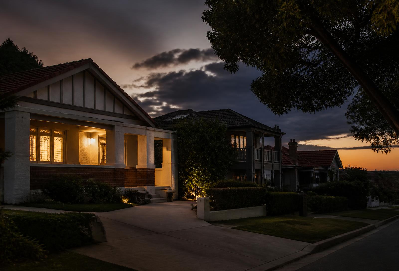 Quiet Adelaide street at dusk with a single home lit and an empty open-inspection driveway