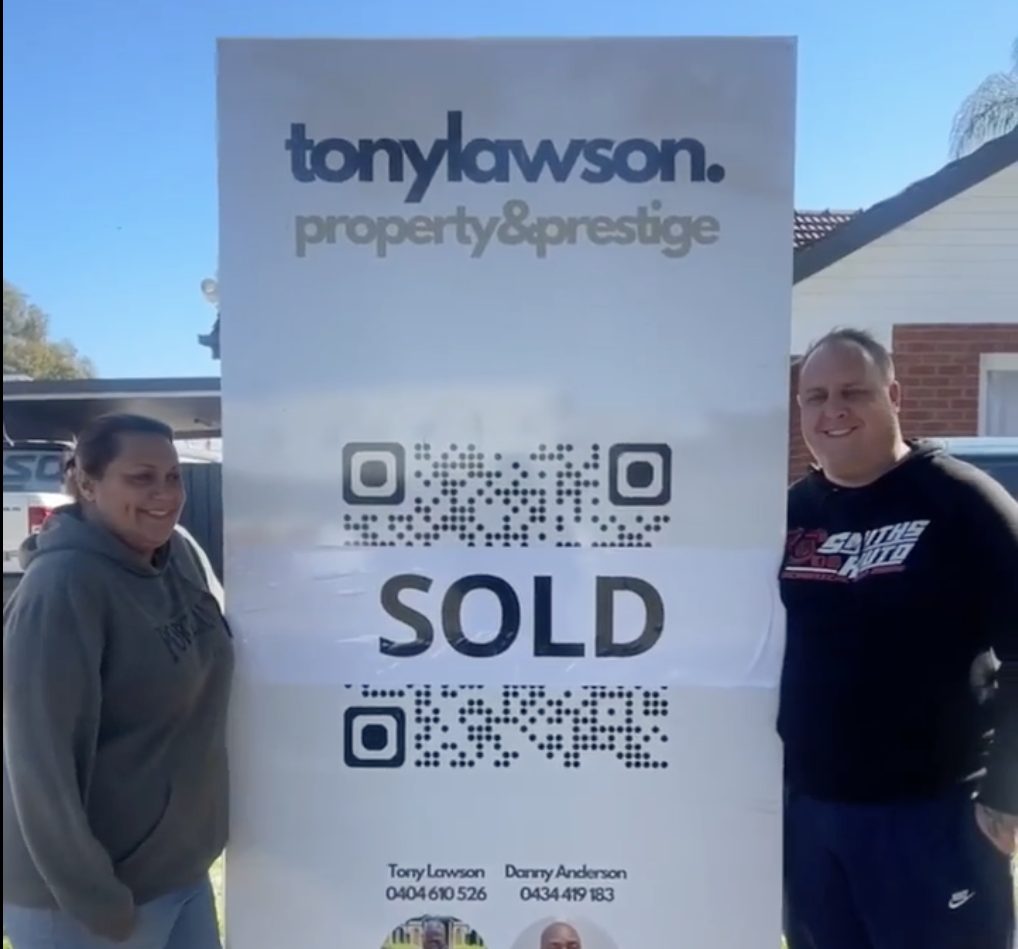 Happy clients with sold sign